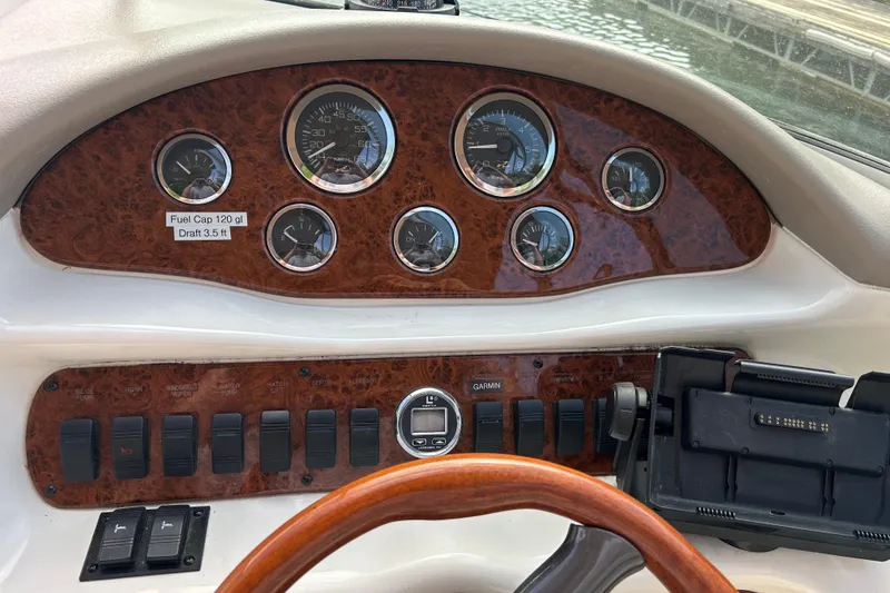 Slide: The Image of 1998 Sea Ray 280 Bow Rider dashboard with gauges and controls. - 74