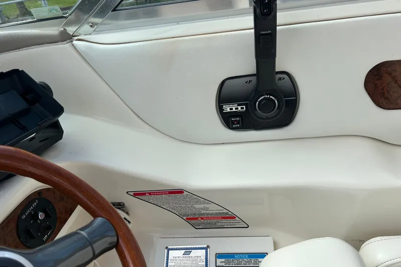 Slide: The Image of 1998 Sea Ray 280 Bow Rider dashboard with throttle controls and warning labels. - 75