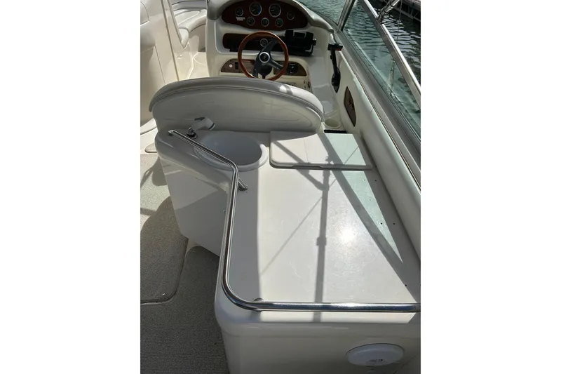 Slide: The Image of 1998 Sea Ray 280 Bow Rider cockpit with steering wheel and dashboard controls. - 79