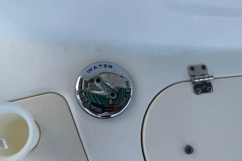 Slide: The Image of Water fill cap on 2008 Boston Whaler 230 Dauntless boat deck. - 33