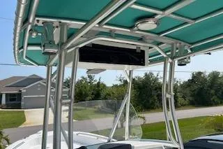Slide: The Image of 2008 Boston Whaler 230 Dauntless boat with teal canopy and sturdy metal frame. - 16