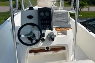 Slide: The Image of 2008 Boston Whaler 230 Dauntless boat dashboard with steering wheel and controls. - 17