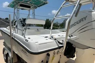 Slide: The Image of 2008 Boston Whaler 230 Dauntless boat with Mercury engine, featuring a sturdy design. - 4