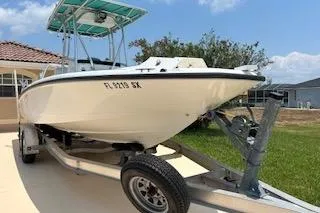 Slide: The Image of 2008 Boston Whaler 230 Dauntless boat on trailer, parked in driveway. - 5
