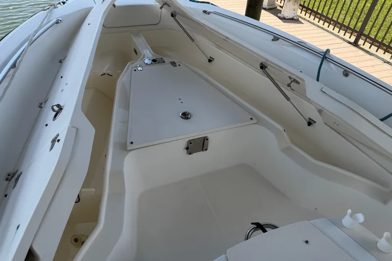 Slide: The Image of 2008 Boston Whaler 230 Dauntless boat interior, showcasing spacious seating and storage areas. - 45
