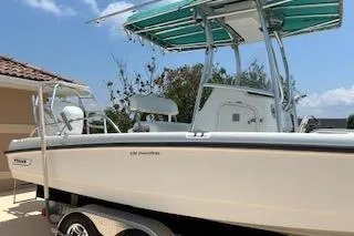 Slide: The Image of 2008 Boston Whaler 230 Dauntless boat on trailer, featuring a T-top and sleek design. - 6