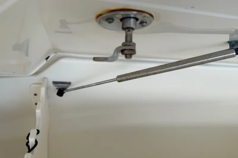 Slide: The Image of Gas strut mechanism inside a 2008 Boston Whaler 230 Dauntless boat compartment. - 41