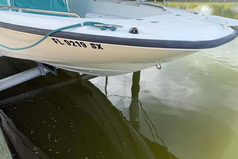 Slide: The Image of 2008 Boston Whaler 230 Dauntless boat docked, displaying registration FL 9219 SX. - 23