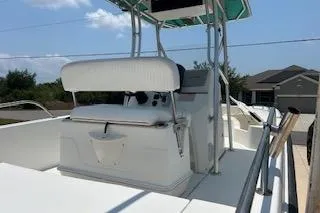 Slide: The Image of 2008 Boston Whaler 230 Dauntless boat with seating and console, outdoors. - 7