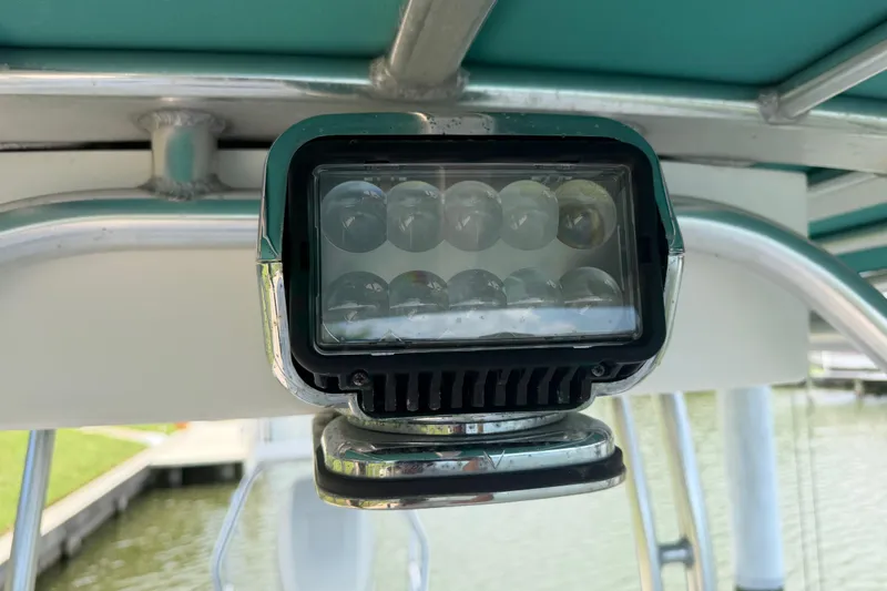 Slide: The Image of LED light on 2008 Boston Whaler 230 Dauntless boat, docked by water. - 34