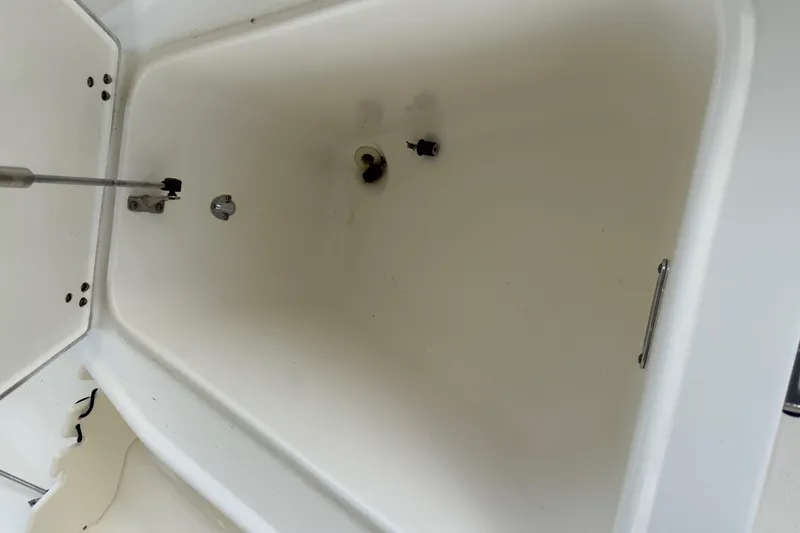 Slide: The Image of Storage compartment of a 2008 Boston Whaler 230 Dauntless boat, featuring clean interior. - 38
