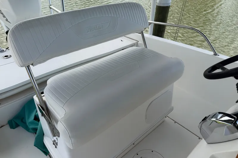 Slide: The Image of 2008 Boston Whaler 230 Dauntless boat interior with white seating and steering wheel. - 32