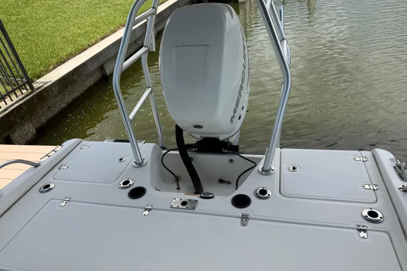 Slide: The Image of Boston Whaler 230 Dauntless 2008 boat stern with motor and ladder by water. - 49