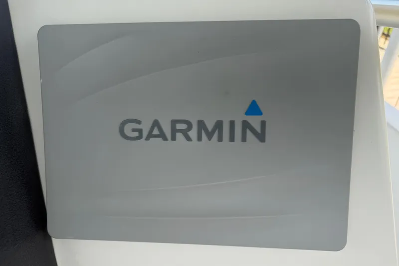 Slide: The Image of Garmin logo on a 2008 Boston Whaler 230 Dauntless boat dashboard. - 29