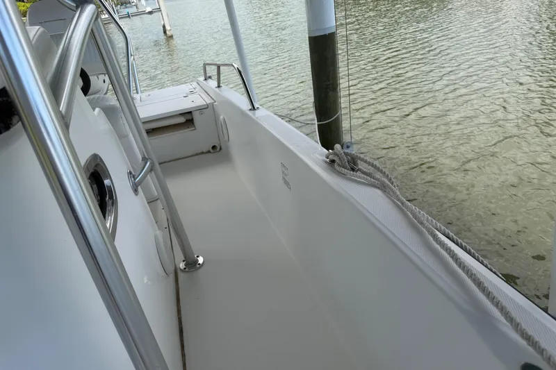 Slide: The Image of 2008 Boston Whaler 230 Dauntless boat interior with railing and water view. - 35