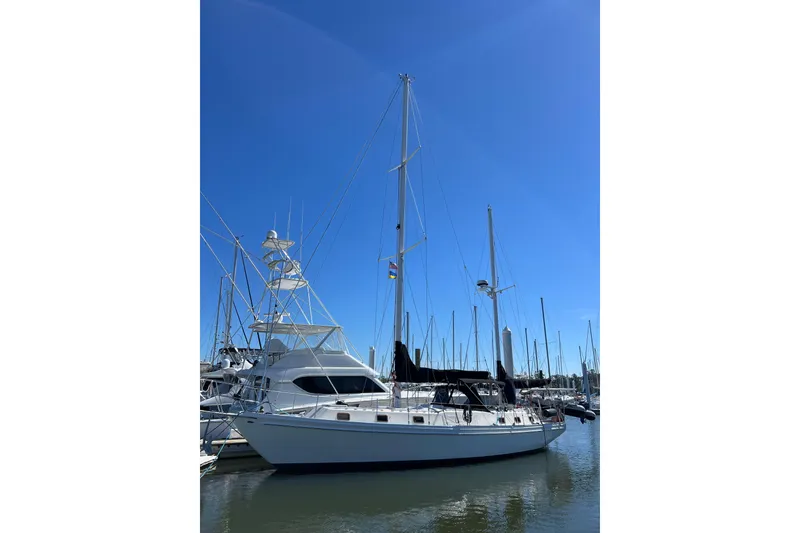 Slide: The Image of 1978 Gulfstar Ketch sailboat docked in a marina under clear blue skies. - 1
