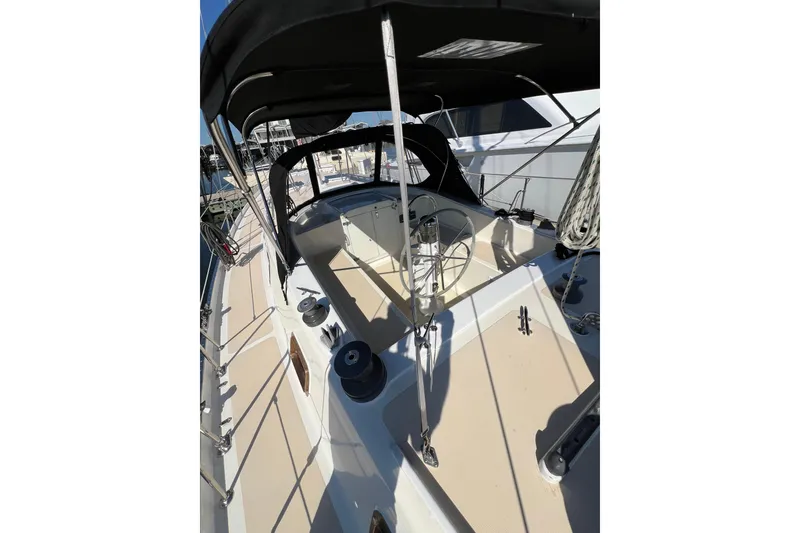 Slide: The Image of 1978 Gulfstar Ketch sailboat deck with steering wheel and canopy in marina. - 11