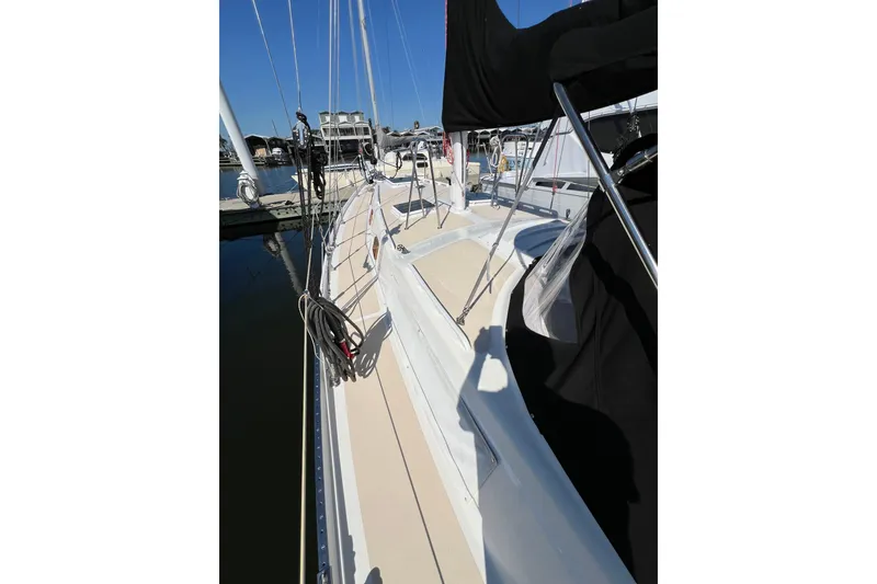 Slide: The Image of 1978 Gulfstar Ketch sailboat deck view at marina under clear blue sky. - 12