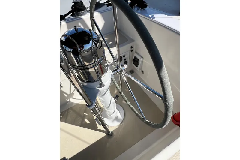 Slide: The Image of Steering wheel of a 1978 Gulfstar Ketch sailboat, featuring polished metal and classic design. - 14