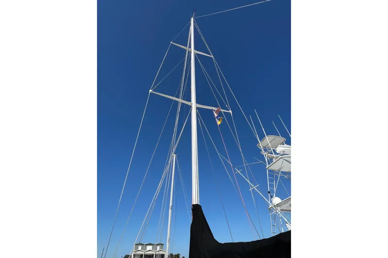Slide: The Image of Tall mast of a 1978 Gulfstar Ketch sailboat against a clear blue sky. - 17
