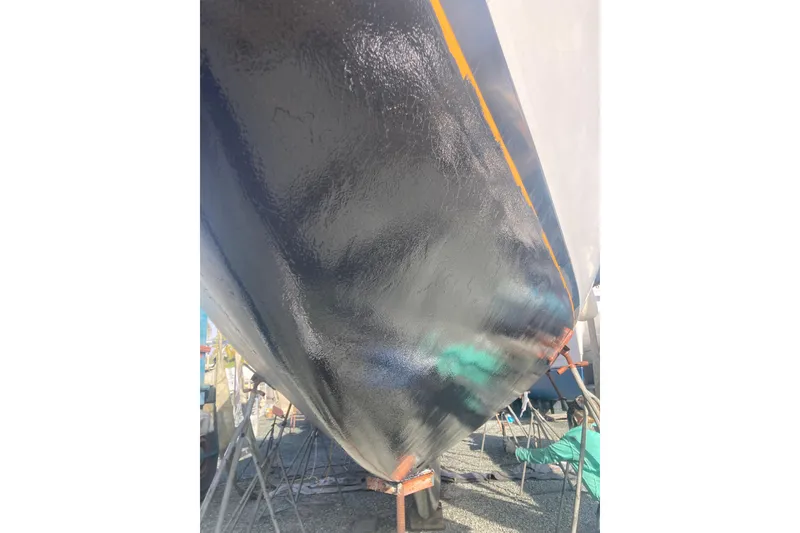 Slide: The Image of 1978 Gulfstar Ketch hull with fresh black paint, supported on stands. - 19