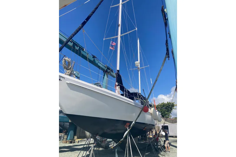 Slide: The Image of 1978 Gulfstar Ketch sailboat on dry dock under clear blue sky. - 2