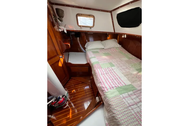 Slide: The Image of Cozy cabin interior of 1978 Gulfstar Ketch with wooden finish and quilted bedding. - 26
