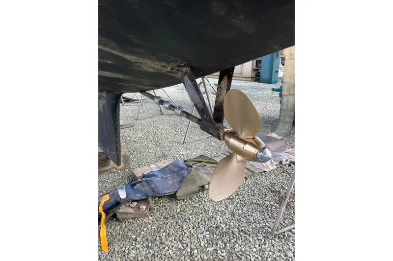 Slide: The Image of Propeller of 1978 Gulfstar Ketch on gravel, showcasing marine hardware. - 44