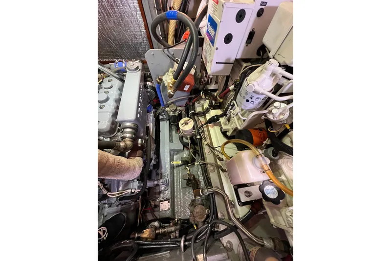 Slide: The Image of Engine compartment of a 1978 Gulfstar Ketch, showcasing mechanical components and wiring. - 48