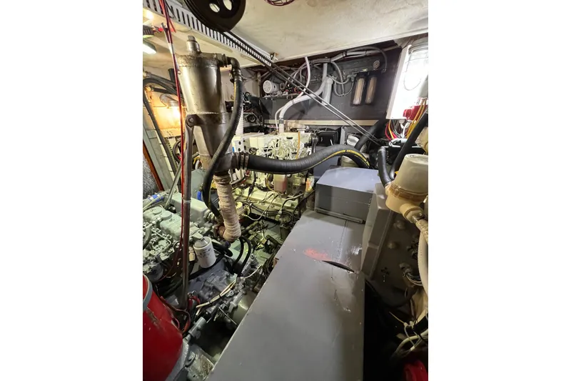 Slide: The Image of Engine room of a 1978 Gulfstar Ketch, showcasing mechanical components and wiring. - 49