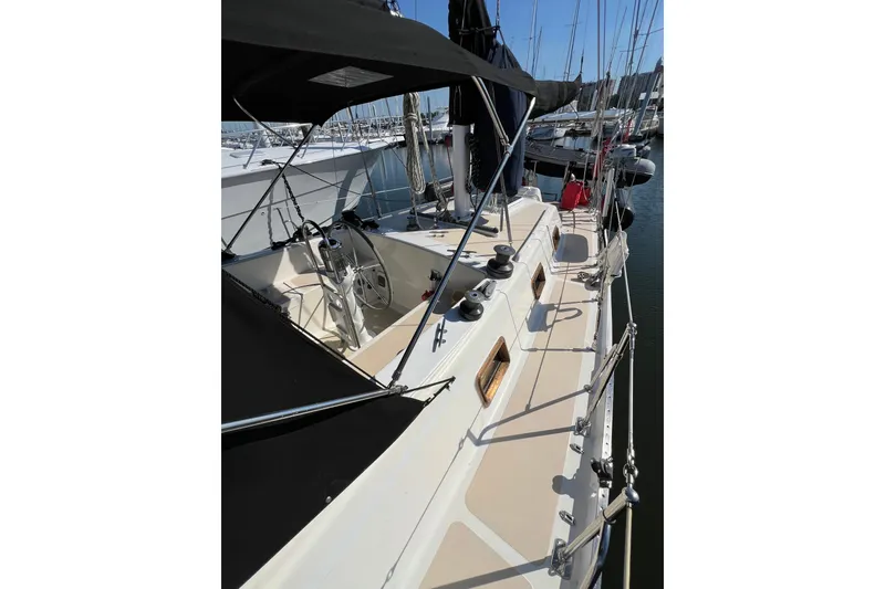 Slide: The Image of 1978 Gulfstar Ketch sailboat docked at marina, featuring sleek deck and steering wheel. - 5