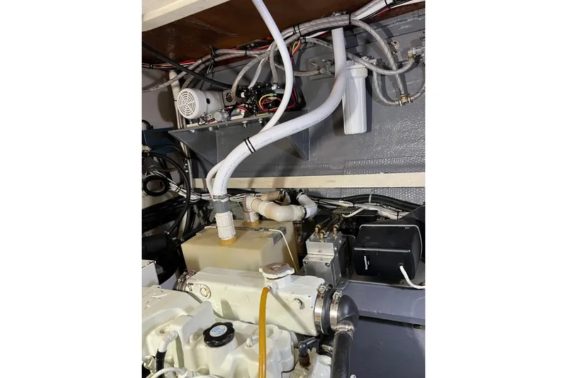 Slide: The Image of Engine room of a 1978 Gulfstar Ketch, showcasing mechanical components and wiring. - 51