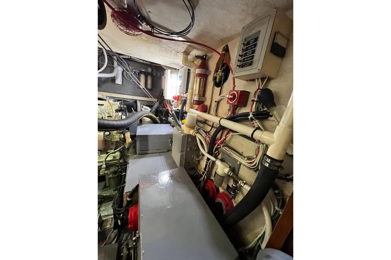 Slide: The Image of Engine room of a 1978 Gulfstar Ketch with visible wiring and machinery components. - 52