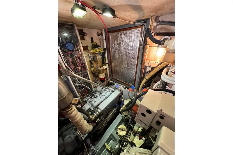 Slide: The Image of Engine room of a 1978 Gulfstar Ketch, featuring mechanical components and wiring. - 53