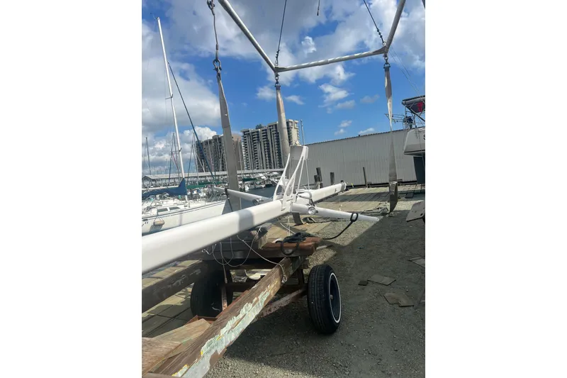 Slide: The Image of 1978 Gulfstar Ketch mast on trailer at marina, under blue sky. - 8