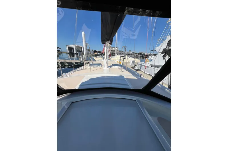 Slide: The Image of 1978 Gulfstar Ketch sailboat deck view at marina, showcasing rigging and clear sky. - 9