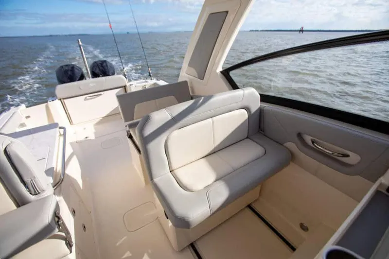 Slide: The Image of Manufacturer Provided Image: 2025 Scout 277 Dorado boat interior with seating, on open water. - 12