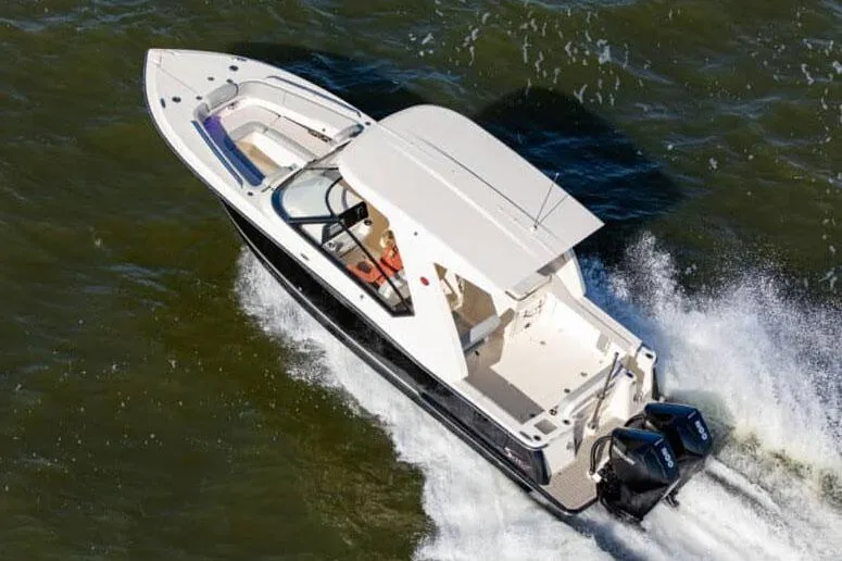 Slide: The Image of Manufacturer Provided Image: 2025 Scout 277 Dorado boat cruising on open water. - 2
