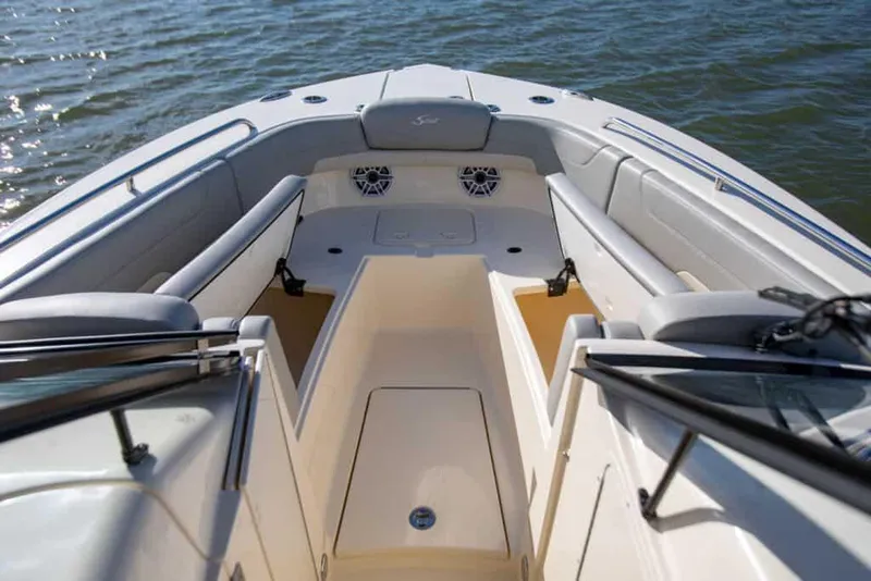 Slide: The Image of Manufacturer Provided Image: 2025 Scout 277 Dorado boat interior with seating and speakers on the water. - 4
