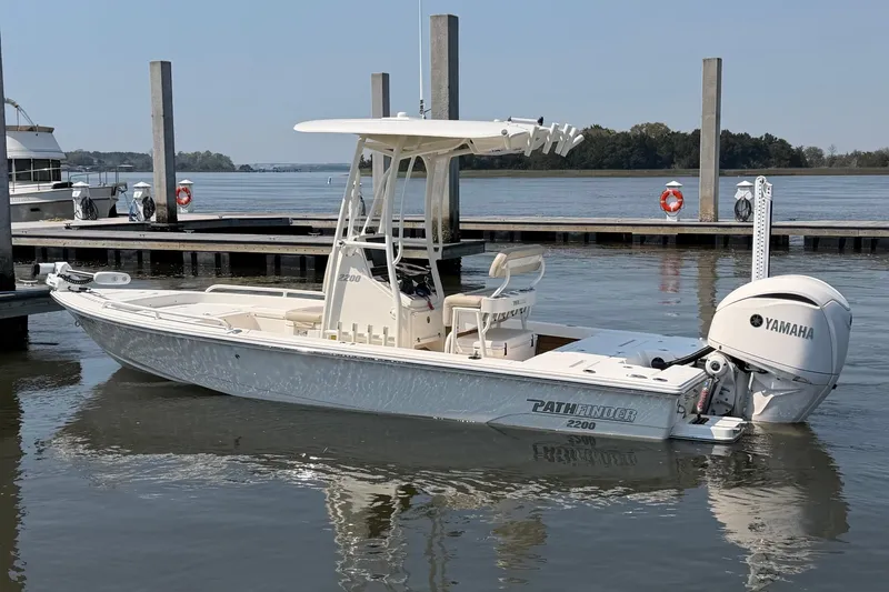 Slide: The Image of 2022 Pathfinder 2200 TRS boat docked, featuring Yamaha outboard motor, calm water setting. - 1