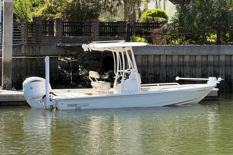 Slide: The Image of 2022 Pathfinder 2200 TRS boat docked by a waterfront with Yamaha engine. - 12