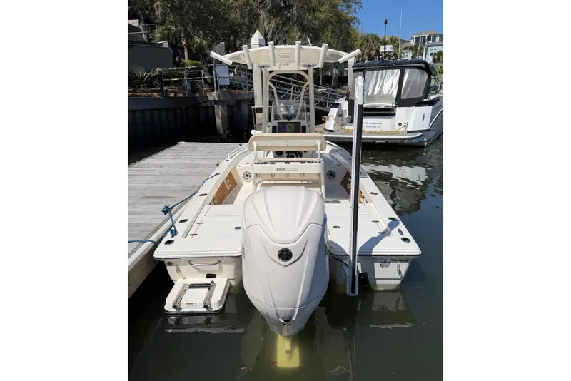 Slide: The Image of 2022 Pathfinder 2200 TRS boat docked at marina, rear view. - 14