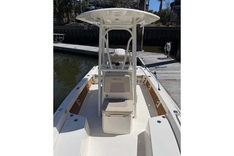Slide: The Image of 2022 Pathfinder 2200 TRS boat docked, featuring center console and seating. - 18