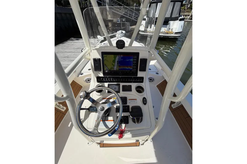 Slide: The Image of 2022 Pathfinder 2200 TRS boat console with steering wheel and navigation display. - 19
