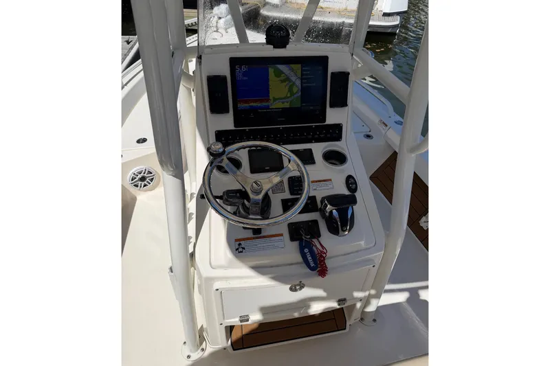 Slide: The Image of 2022 Pathfinder 2200 TRS boat console with steering wheel and navigation display. - 20
