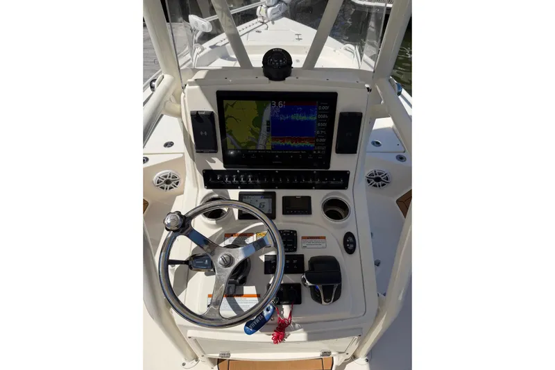 Slide: The Image of 2022 Pathfinder 2200 TRS boat console with steering wheel and navigation display. - 21