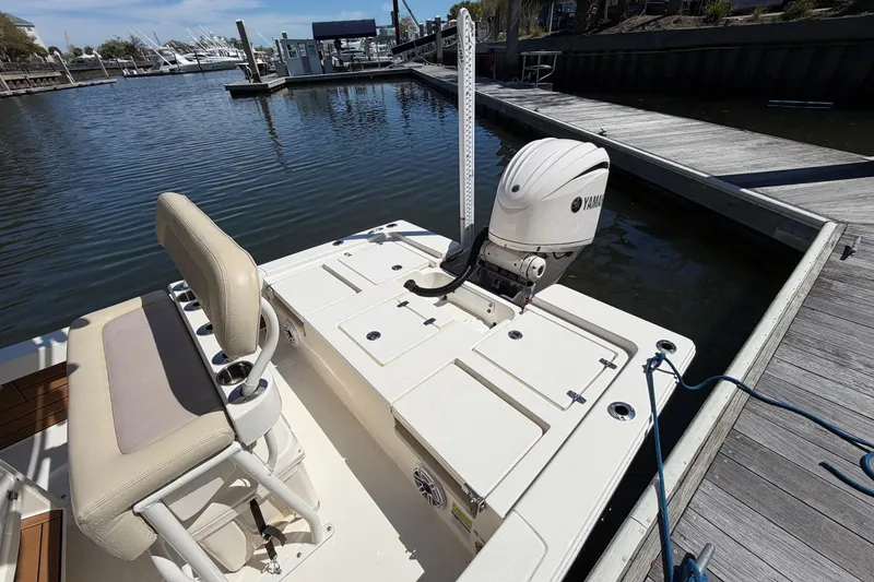 Slide: The Image of 2022 Pathfinder 2200 TRS boat docked, featuring Yamaha outboard motor and comfortable seating. - 25