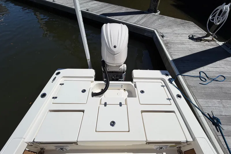 Slide: The Image of 2022 Pathfinder 2200 TRS boat stern view with outboard motor at dock. - 26