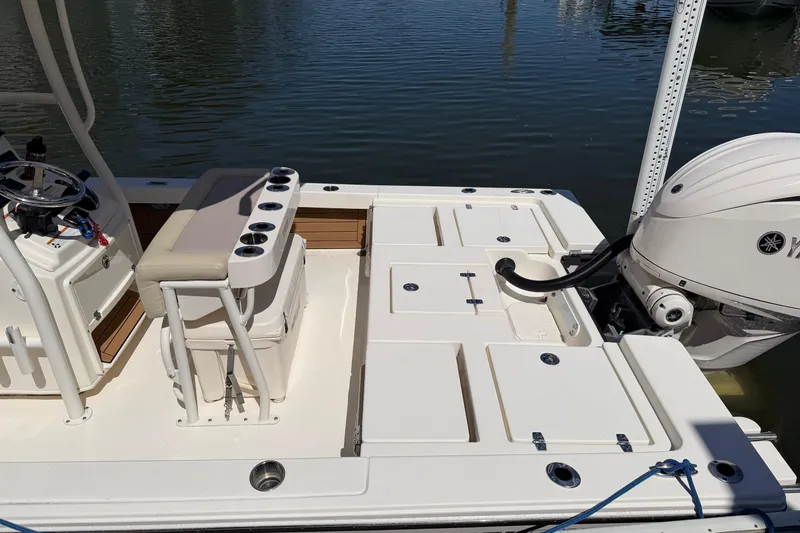 Slide: The Image of 2022 Pathfinder 2200 TRS boat with Yamaha outboard motor, featuring spacious deck and seating. - 27