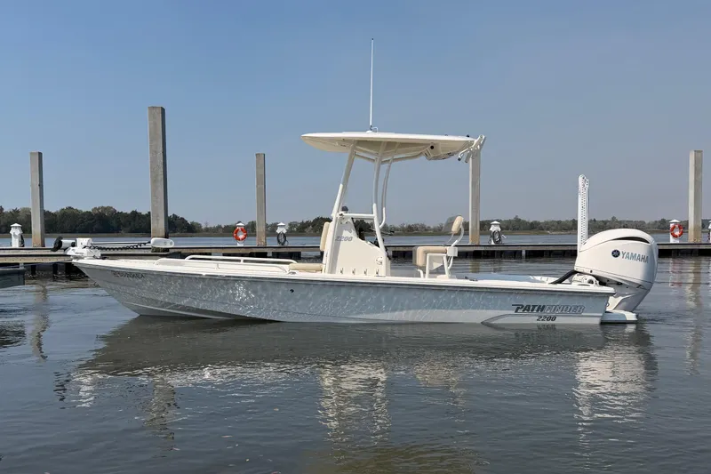 Slide: The Image of 2022 Pathfinder 2200 TRS boat docked, featuring Yamaha outboard motor, calm water setting. - 3